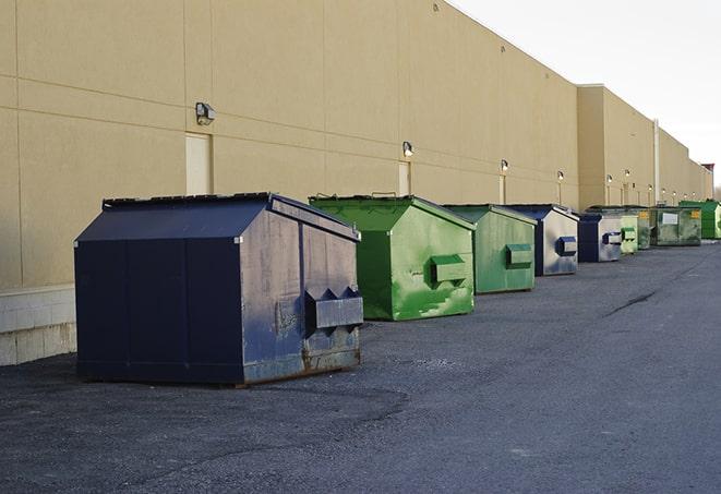 a crowd of dumpsters of all colors and sizes at a construction site in Chatfield